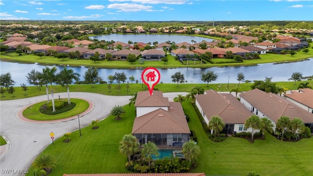 birds eye view of property with a water view