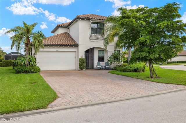 mediterranean / spanish home featuring a front lawn, an attached garage, a tile roof, and stucco siding