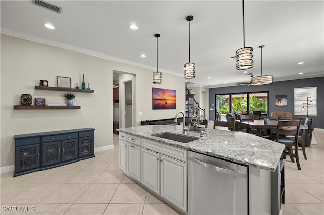 kitchen with dishwasher, sink, hanging light fixtures, crown molding, and a kitchen island with sink