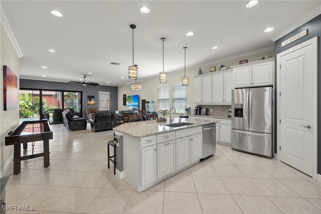 kitchen featuring white cabinetry, sink, an island with sink, and stainless steel appliances