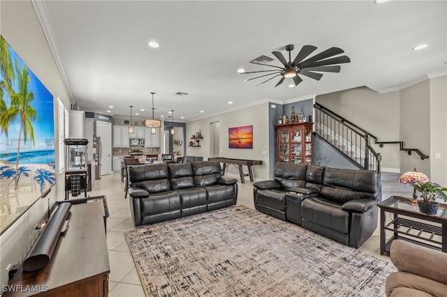 living room featuring light tile patterned floors, visible vents, ornamental molding, and stairway