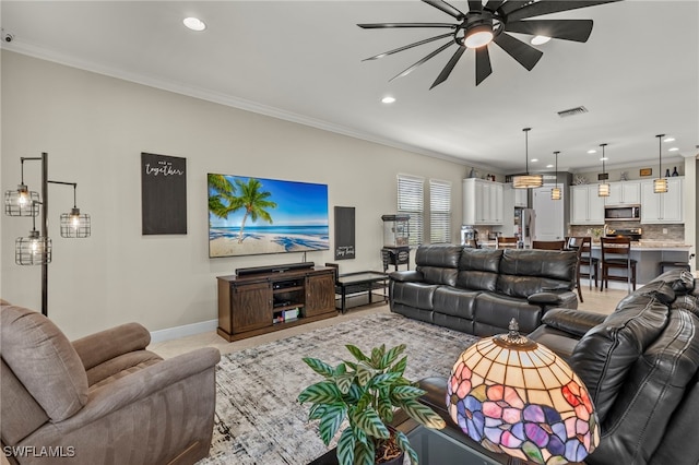 living room featuring ceiling fan and crown molding