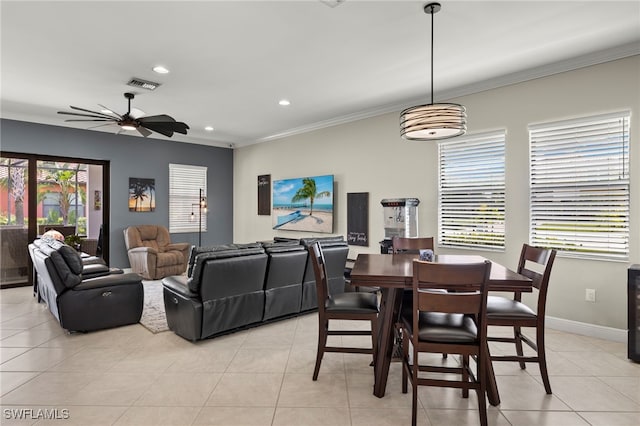 dining area featuring crown molding, light tile patterned floors, and ceiling fan