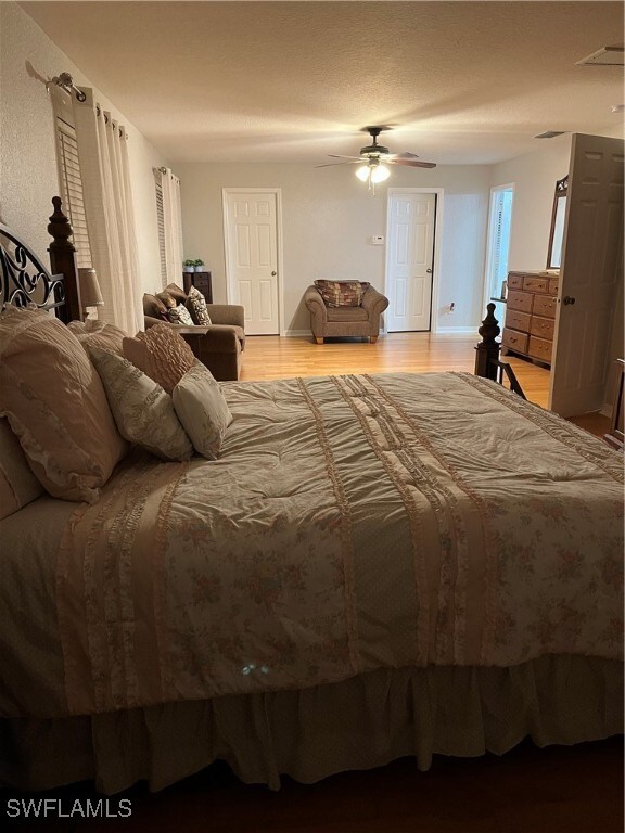 bedroom with light hardwood / wood-style floors and ceiling fan