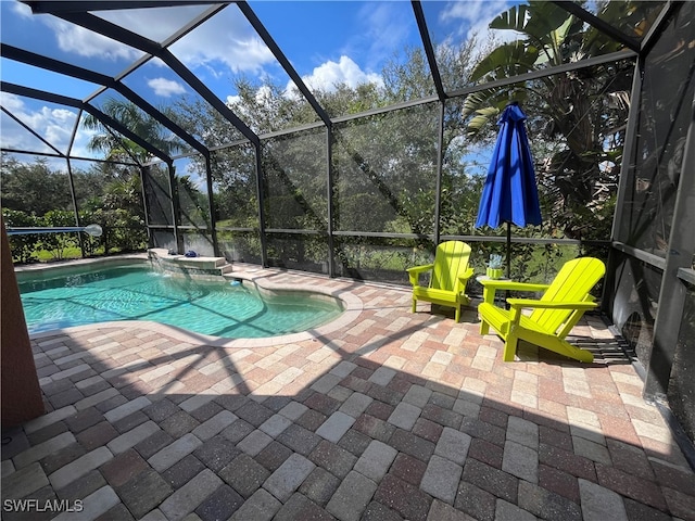 view of swimming pool featuring a patio and glass enclosure