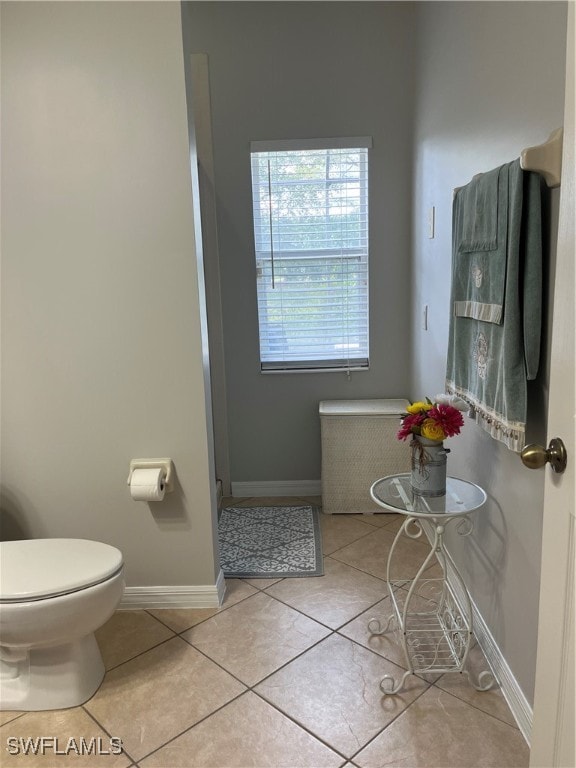 bathroom with toilet and tile patterned flooring