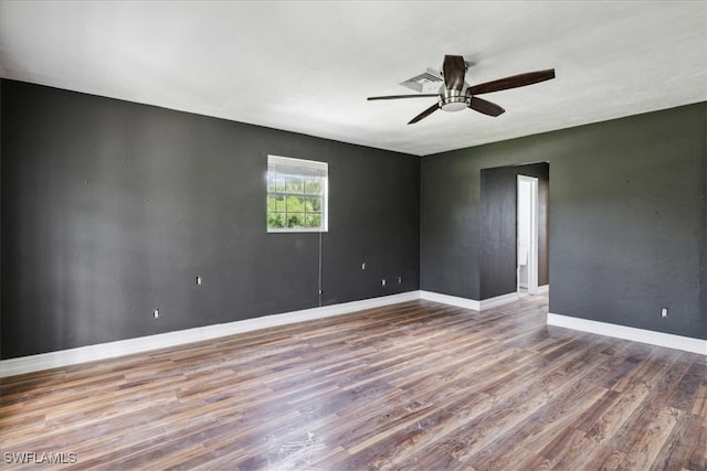 empty room featuring ceiling fan and hardwood / wood-style flooring