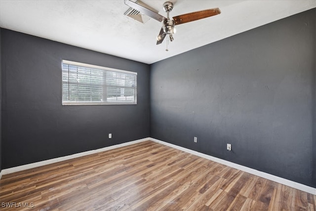 empty room with ceiling fan and hardwood / wood-style floors