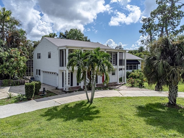 view of front of home with a garage and a front lawn