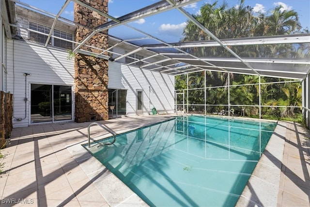 view of swimming pool with a patio area and glass enclosure