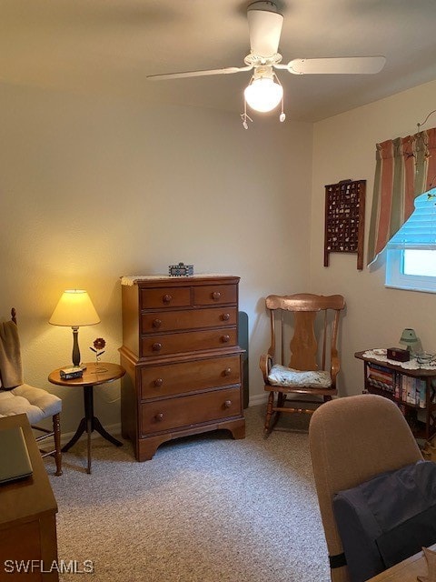 sitting room featuring light carpet and ceiling fan