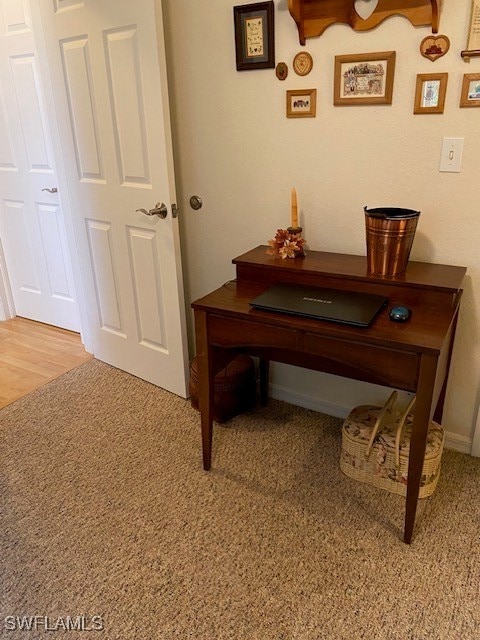 home office with light hardwood / wood-style floors