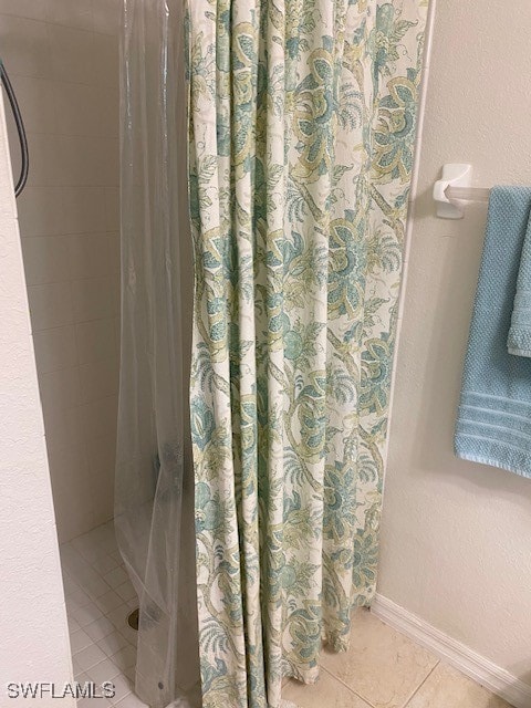 bathroom featuring a shower with shower curtain and tile patterned flooring