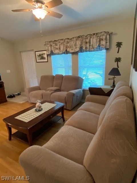 living room with hardwood / wood-style floors and ceiling fan