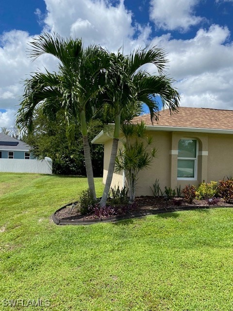 view of side of property featuring a yard