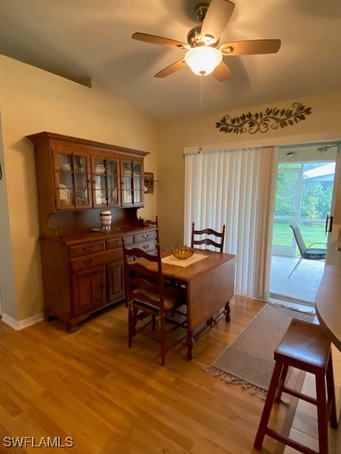 dining room with light hardwood / wood-style flooring, lofted ceiling, and ceiling fan