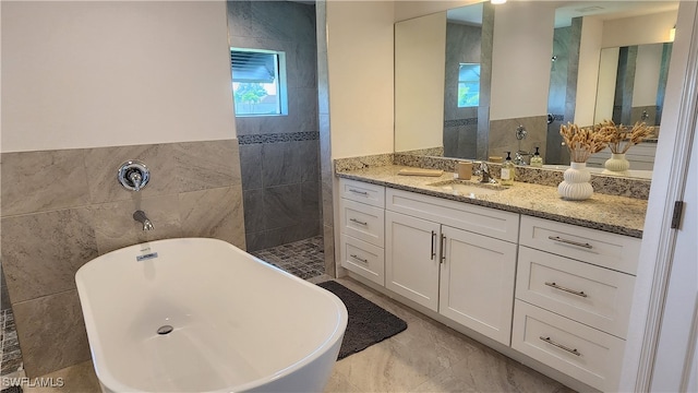 bathroom featuring vanity, tile walls, and plus walk in shower