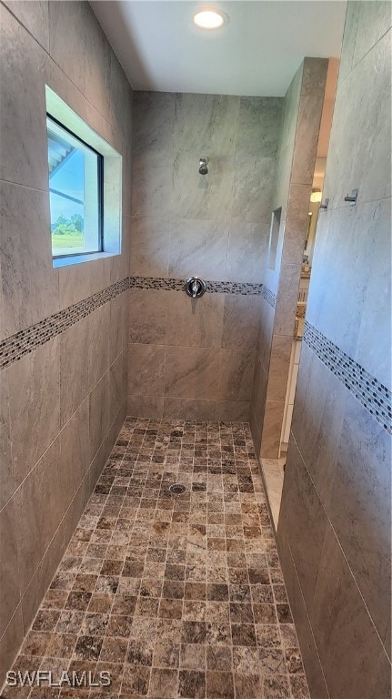 bathroom with a tile shower