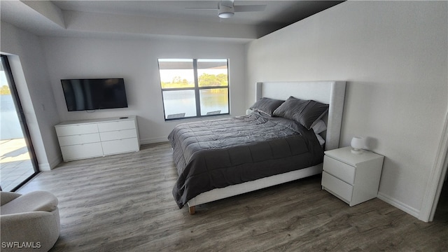 bedroom featuring wood-type flooring, access to exterior, and ceiling fan