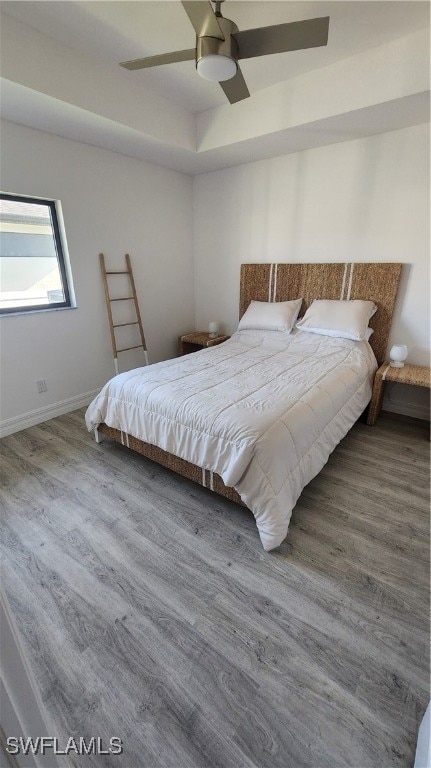 bedroom with ceiling fan and wood-type flooring