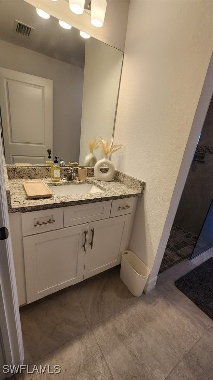 bathroom featuring vanity and tile patterned flooring