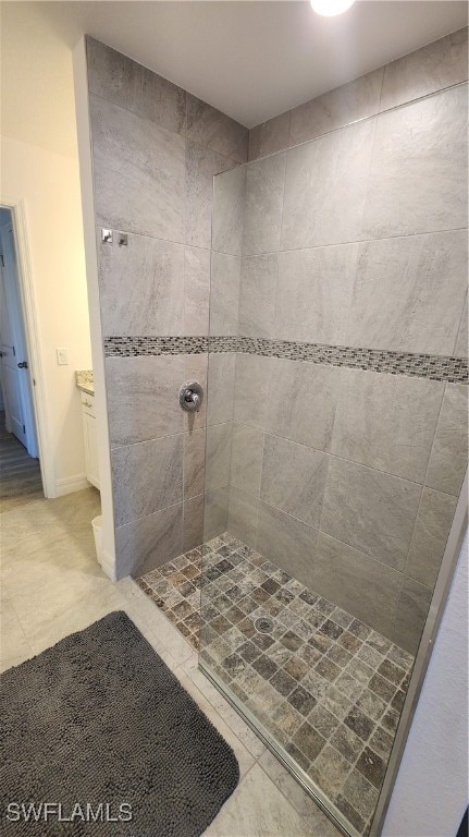 bathroom with tiled shower