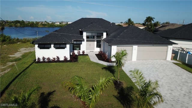 view of front of home featuring a water view and a front lawn