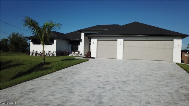 view of front of property featuring a front lawn and a garage