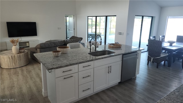 kitchen featuring dishwasher, white cabinetry, hardwood / wood-style floors, and sink