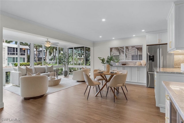 dining space featuring ceiling fan and light hardwood / wood-style floors