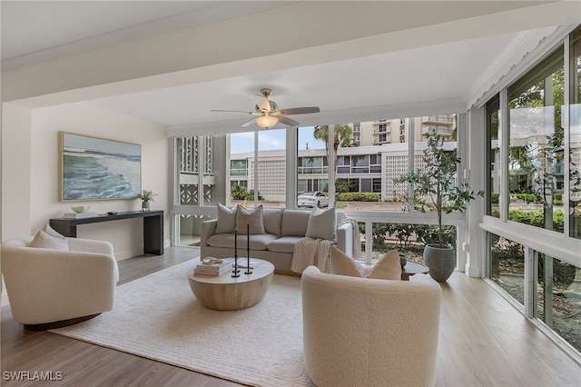 sunroom / solarium featuring ceiling fan and a wealth of natural light