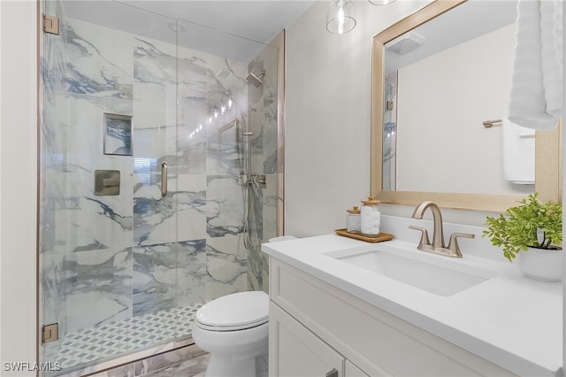 bathroom featuring walk in shower, vanity, and toilet