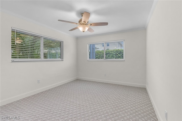 carpeted spare room featuring crown molding and ceiling fan