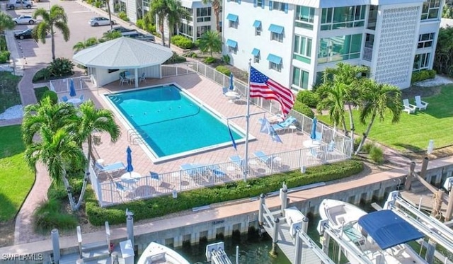 view of pool featuring a boat dock and a patio area