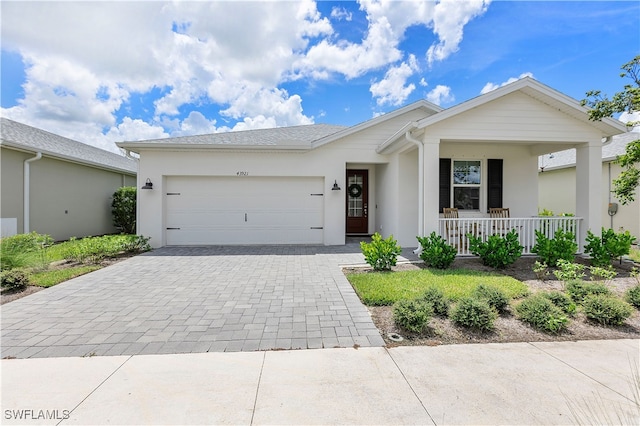 ranch-style home featuring a garage and covered porch