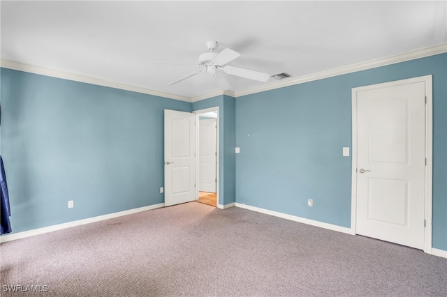 spare room with ceiling fan, carpet, and ornamental molding