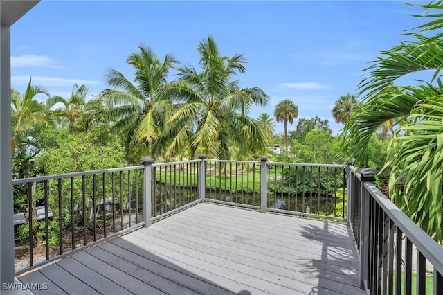 wooden terrace featuring a water view