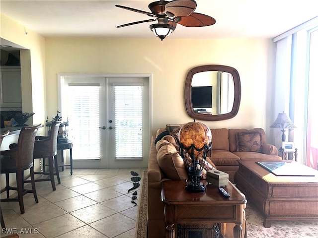 living room with french doors, light tile patterned floors, and ceiling fan