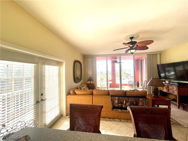 living room featuring a healthy amount of sunlight, light tile patterned floors, and ceiling fan