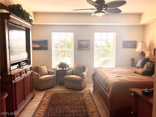 bedroom with multiple windows, light tile patterned floors, and ceiling fan