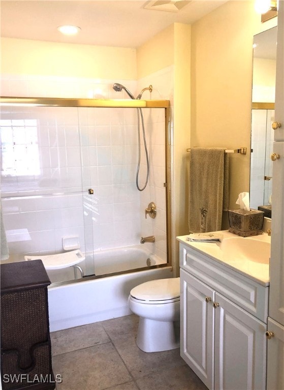 full bathroom with tile patterned flooring, vanity, toilet, and enclosed tub / shower combo