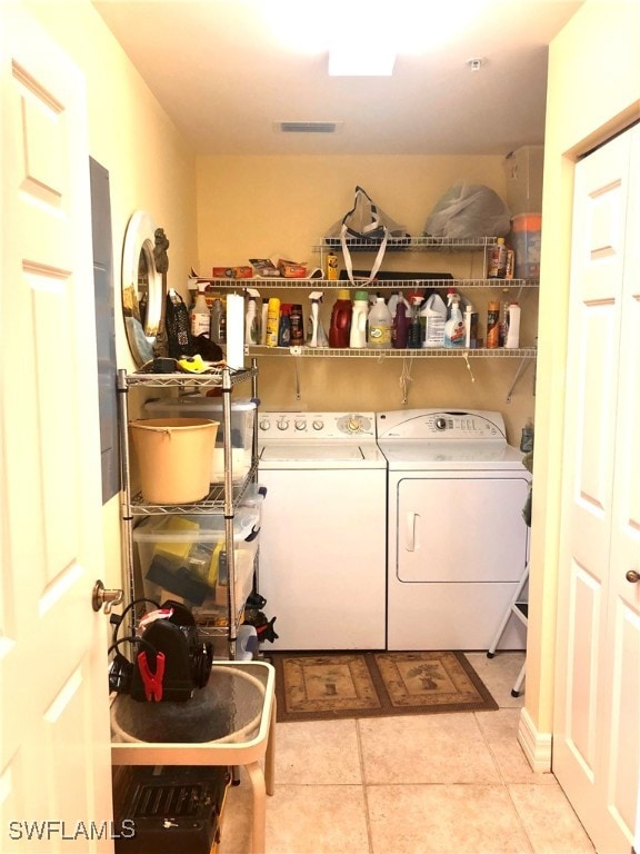 washroom with separate washer and dryer and light tile patterned floors