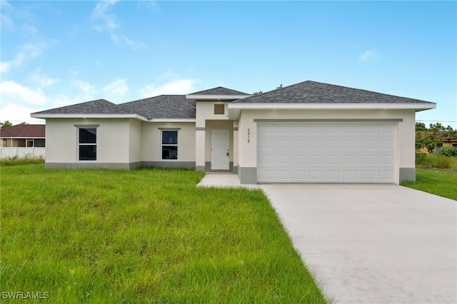 view of front of property with a garage and a front yard