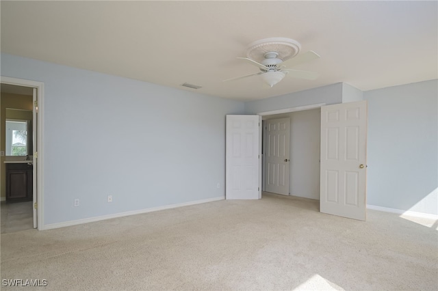 unfurnished bedroom featuring light colored carpet and ceiling fan