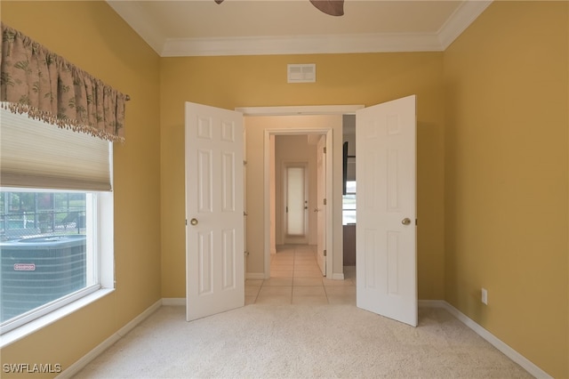 unfurnished bedroom with light carpet, crown molding, and ceiling fan