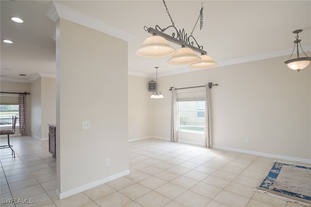 spare room with ornamental molding, light tile patterned flooring, and a healthy amount of sunlight