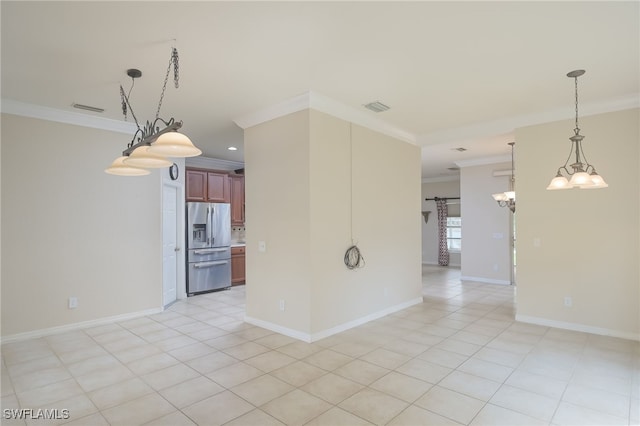 empty room featuring ornamental molding, light tile patterned floors, and a notable chandelier