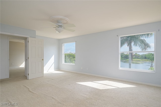 spare room with light carpet and ceiling fan