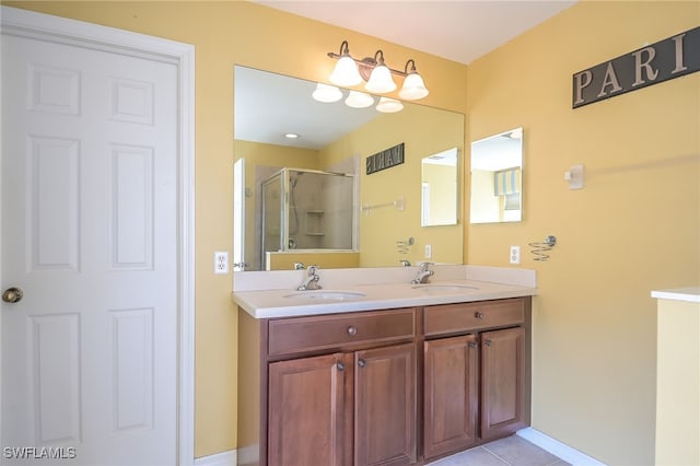 bathroom featuring tile patterned flooring, vanity, and a shower with shower door