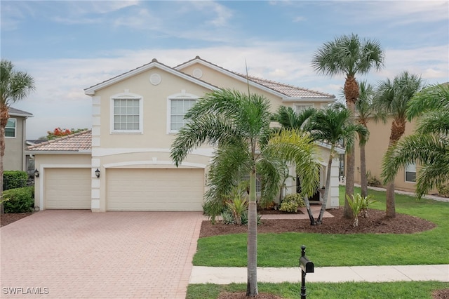 view of front of property featuring a front yard and a garage